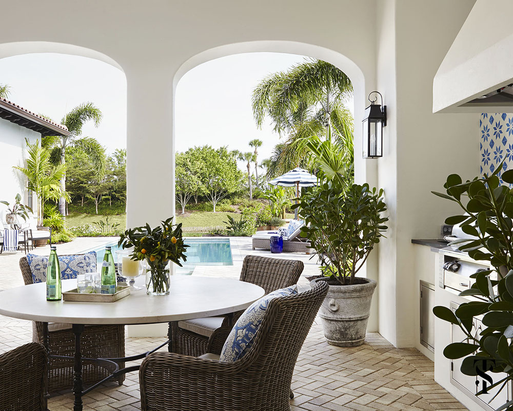 Naples Interior Design project - interior designer Summer Thornton - lanai with outdoor dining table and blue and white details near the outdoor pool - www.summerthorntondesign.com