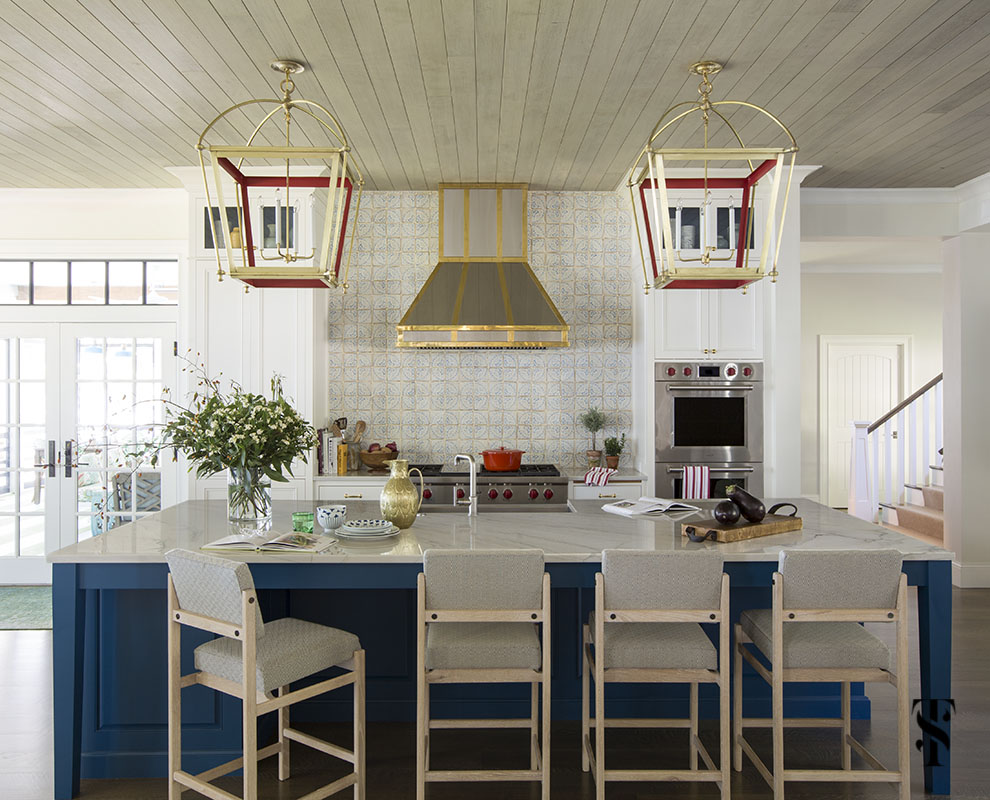 wisconsin lake house with wood ceiling, navy blue kitchen with pagoda style lanterns, and stainless steel and brass hood by rangecraft, interior design by summer thornton www.summerthorntondesign.com