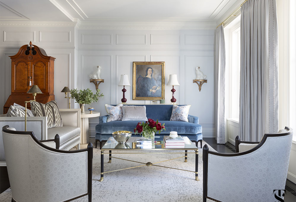 formal living room with blue silk velvet sofa, staffordshire dogs and oil portraiture, interior design by Summer Thornton in Chicago's Palmolive building. For more photos, visit www.SummerThorntonDesign.com