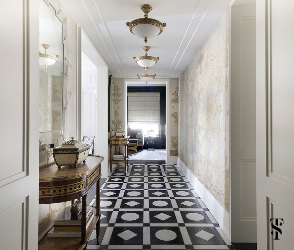 An exceptional graphic marble black and white floor in a hallway of Gracie wallpaper as designed & renovated by Summer Thornton for a condo in Chicago's Palmolive Building. For more photos visit www.SummerThorntonDesign.com.