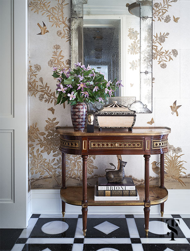 gracie wallpaper adorns the walls in an opulant foyer designed & remodeled by Summer Thornton complete with wild geometric patterned marble floor inspired by a palace. For more photos visit www.SummerThorntonDesign.com
