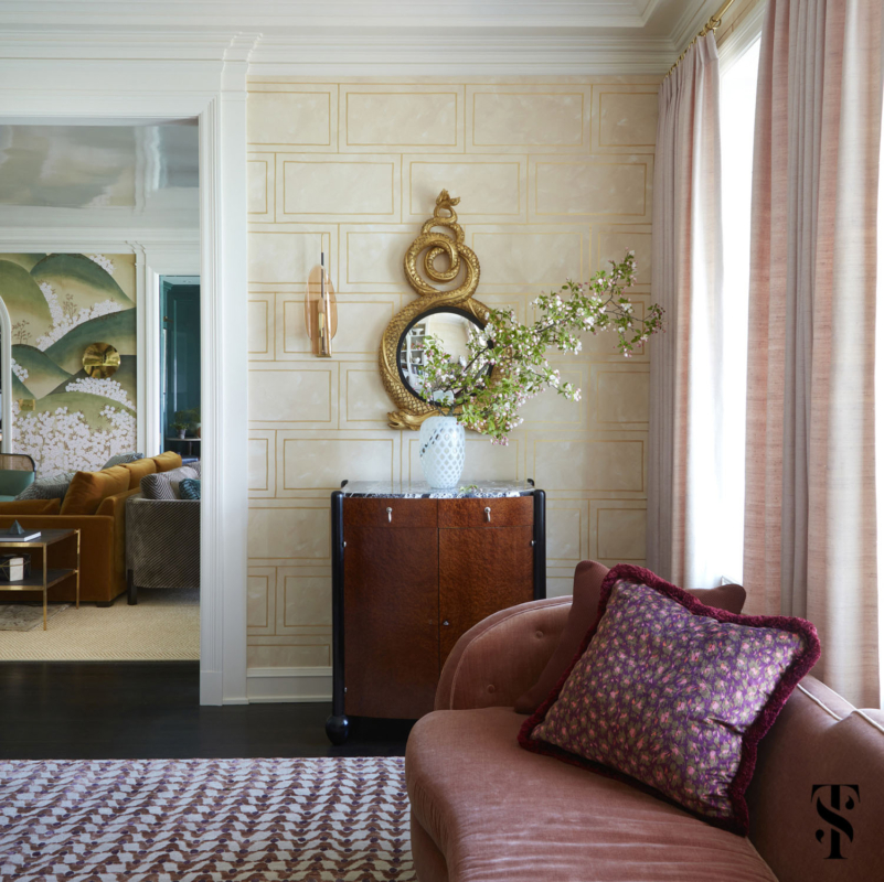 The dining room of a Chicago co-op designed by Summer Thornton featuring a custom designed hand painted wallcovering & a hand carved & gilded mirror.