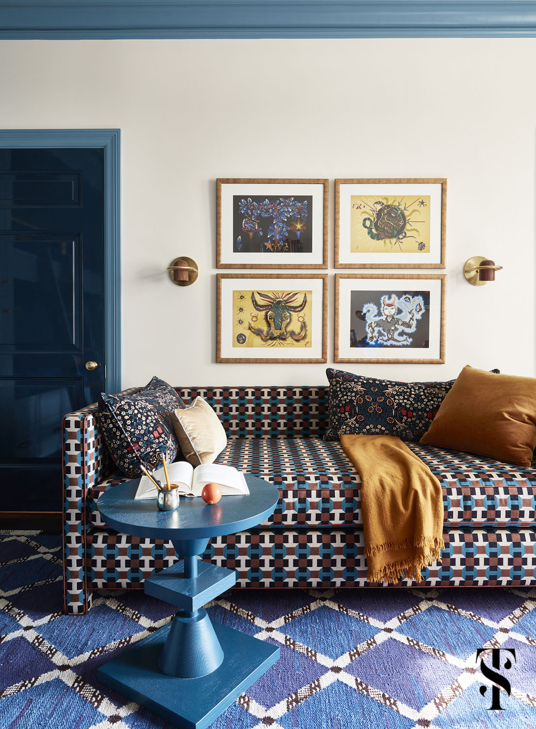 A sophisticated boy's room by Summer Thornton with dark blue doors in high gloss, aqua trim, and Hermes upholstered day bed.