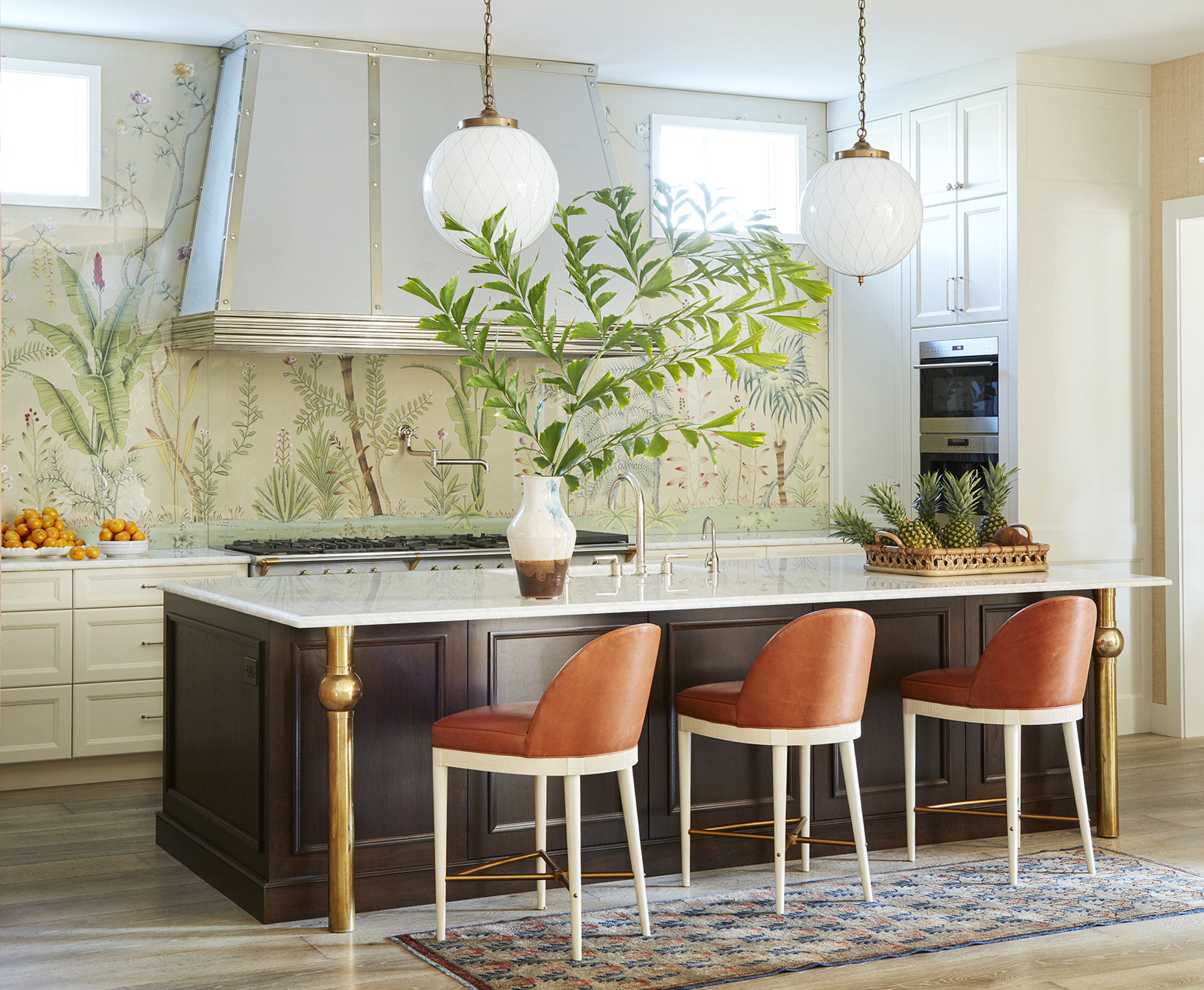 Kitchen design by Summer Thornton creates visual interest in this Old Naples Florida home with de Gournay wallpaper backsplash
