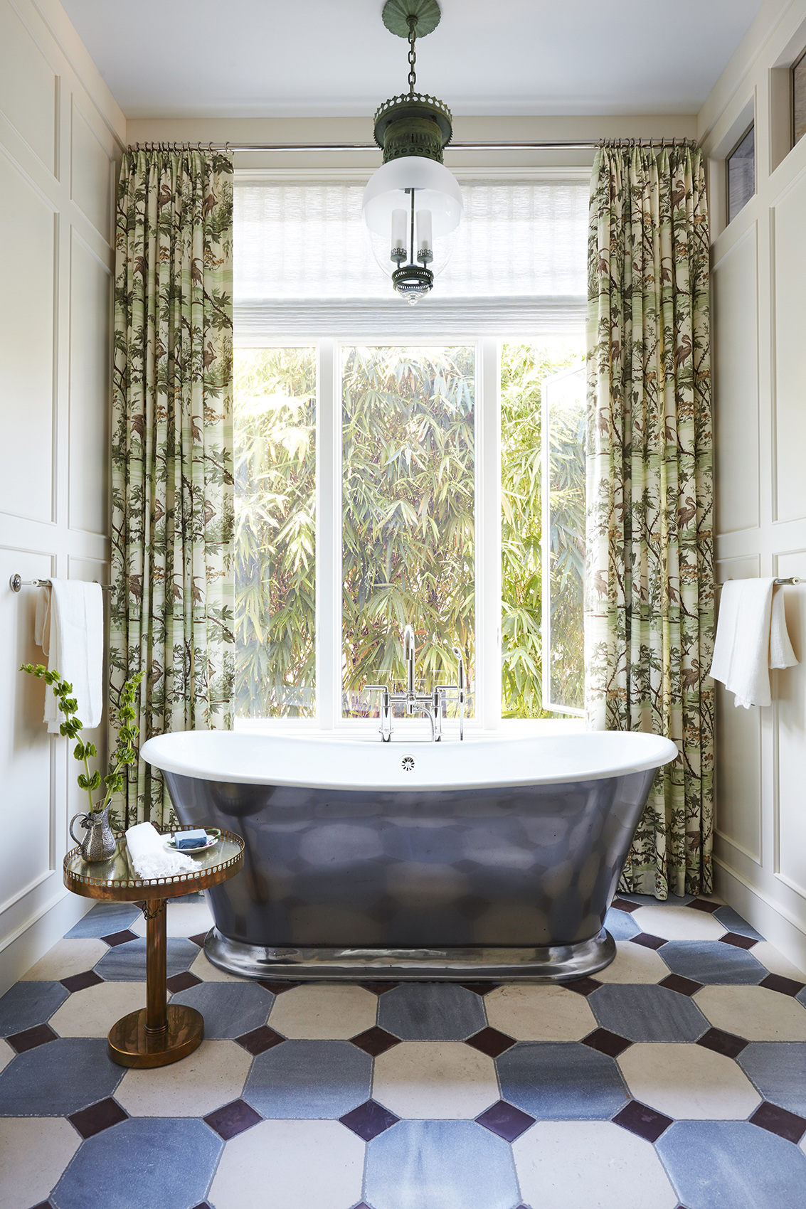 Naples Florida Bathroom design by Summer Thornton with a soaking tub, patterned floor, and draperies.