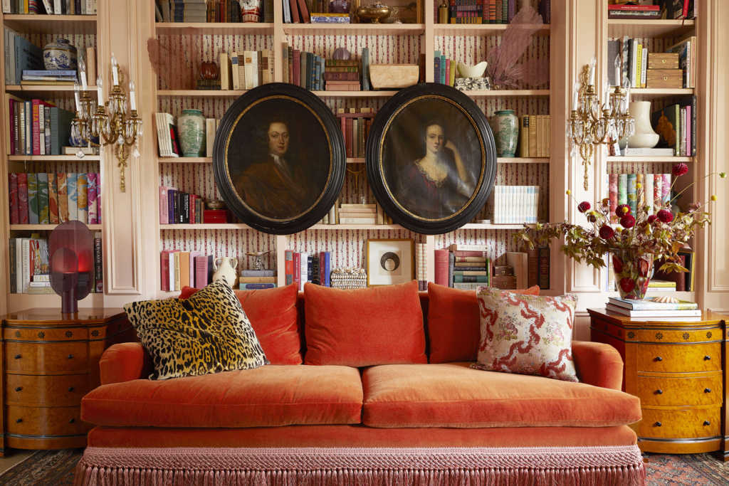 Summer Thornton’s personal Chicago residence designed by Summer Thornton. Living room features a coral Mohair sofa by Montauk, high gloss pink book cases, portraits, and a collection of curated treasures.