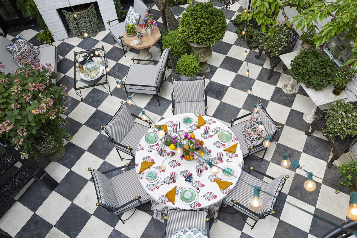 Summer Thornton’s personal Chicago residence designed by Summer Thornton. Outdoor Patio features custom wrought iron railings, white brick exterior, and New Orleans inspired limestone and granite floors.