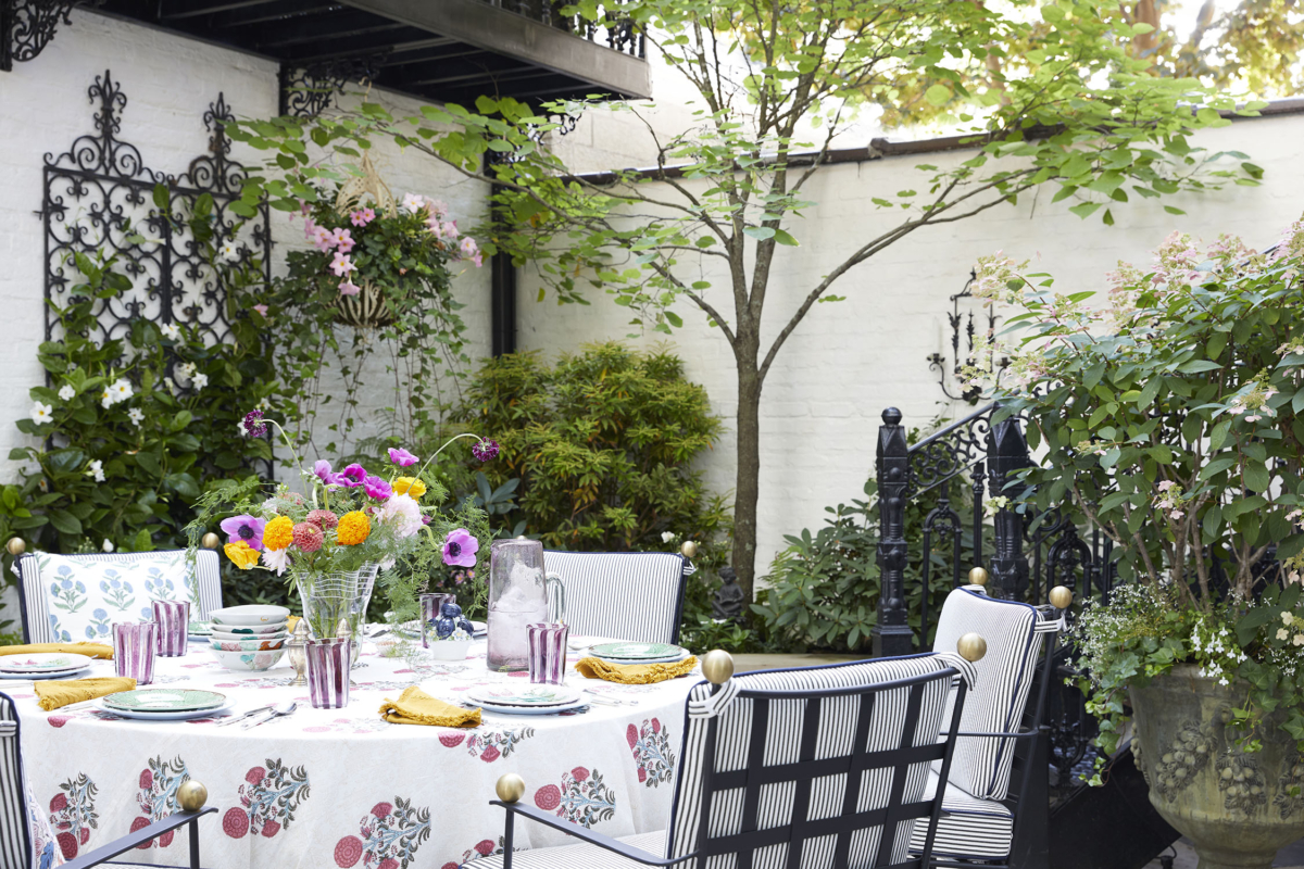 Summer Thornton’s personal Chicago residence designed by Summer Thornton. Outdoor Patio features custom cast iron railings from New Orleans, white brick exterior, and a beautiful tabletop perfect for entertaining.