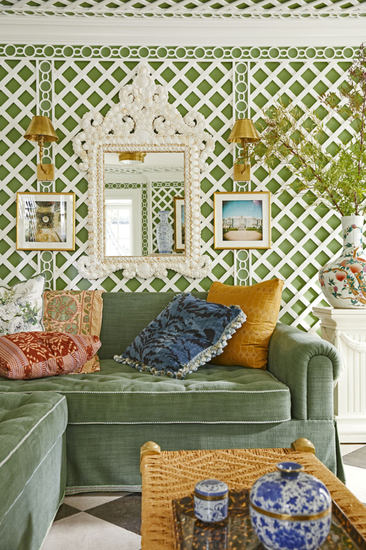 Summer Thornton’s personal Chicago residence designed by Summer Thornton. Garden room features Boxwood green walls clad in lattice work, wicker furniture, New Orleans inspired checkered flooring and French doors.