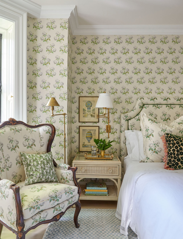 Summer Thornton’s personal Chicago residence designed by Summer Thornton. Guest Bedroom features upholstery that matches the wallcovering, a custom matching headboard and rattan bedside tables.
