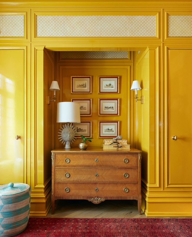 Summer Thornton’s personal Chicago residence designed by Summer Thornton. This little gentleman’s bedroom features Russian red carpet, glossy yellow wall panelling, William Morris textiles and Fornasetti clouds.